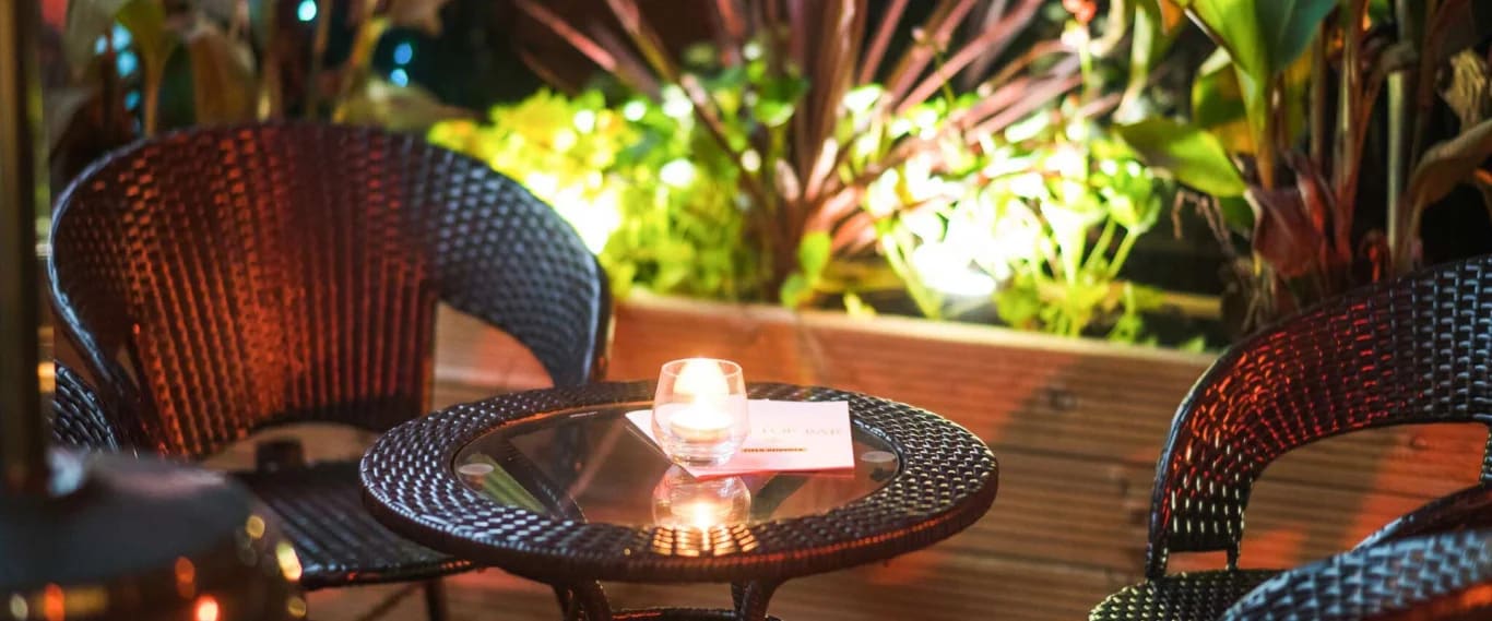 A candlelit table on the terrace at night